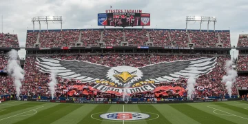 Massive eagle tifo displayed by US soccer fans in a vibrant stadium