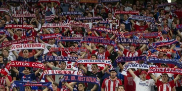 Passionate US soccer fans cheering in a vibrant stadium