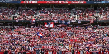 Packed soccer stadium with enthusiastic US fans, vibrant atmosphere