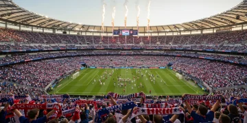 Vibrant US soccer stadium with cheering fans and flags