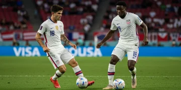 Christian Pulisic and Timothy Weah showcasing their dynamic play on a soccer field in USMNT kits.