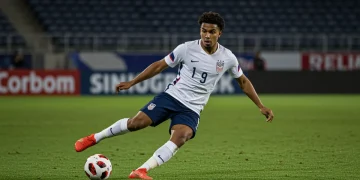 Young American defender showcasing agility and determination on a soccer field.